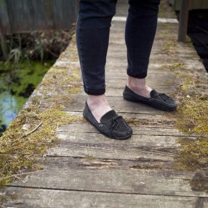 Female,Legs,In,Jeans,Standing,On,A,Bridge,Across,A